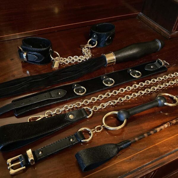Bondage collection including handcuffs, sextoy whip, chocker, leash, gag and riding crop.