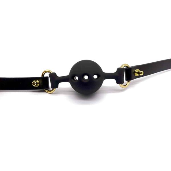 Black leather and silicone baillon in the shape of a ball with holes for breathing, gold finish UPKO at Brigade Mondaine