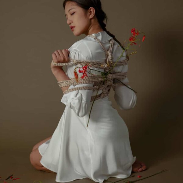 Cremefarbenes Shibari-Seil der Marke UPKO. Das Model trägt ein Seilgeflecht mit einer Länge von 10 m und einem Schnurdurchmesser von 6 mm.