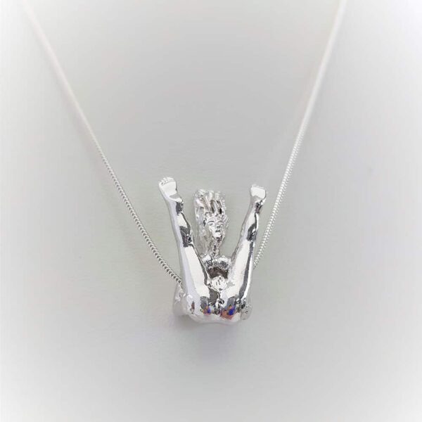 Rosebuds silver necklace, featuring a silver woman showing us her anatomy, in fact she has her legs apart.