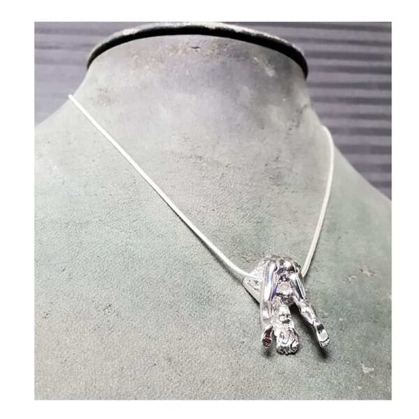Rosebuds silver necklace, featuring a silver woman showing us her anatomy, in fact she has her legs apart.
