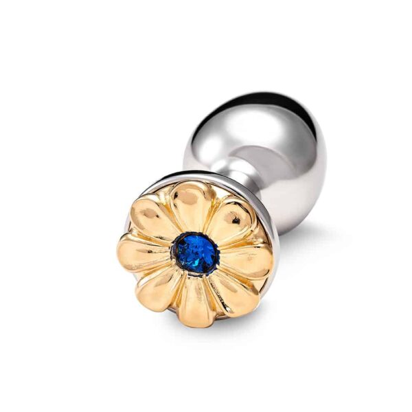 Accesorio plug anal en bronce plateado y decoración floral en oro y pistilo azul.