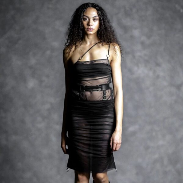 Demure black silk bodysuit by Gonzales worn by a model, play on transparency and clean lines, selection Brigade Mondaine Paris.