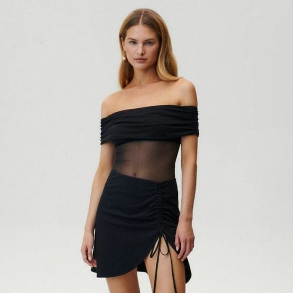 UNDRESS CODE - LIBRA Bodysuit Photo d'une Femme de Devant portant un Body Epaules Nues en Résille avec un Drapé en Viscose Opaque au niveau de la Poitrine et des Bras avec une Jupe couleur Noir