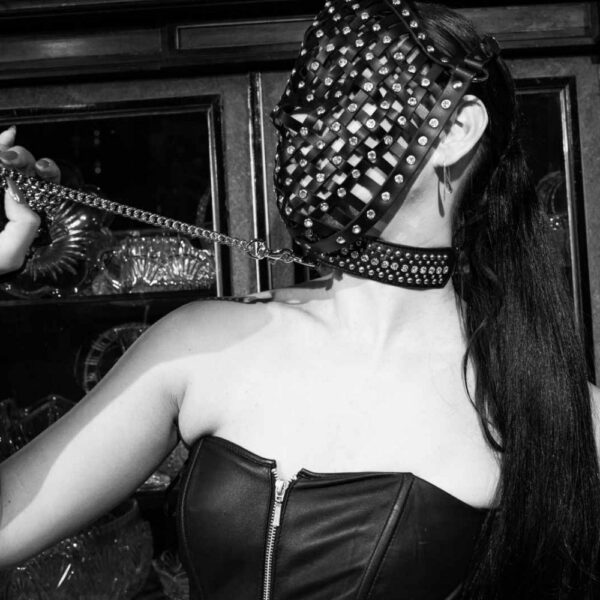 Photo of a woman wearing a Bondage Necklace in Black Nubuck Leather with Crystals and a Small Metal Ring