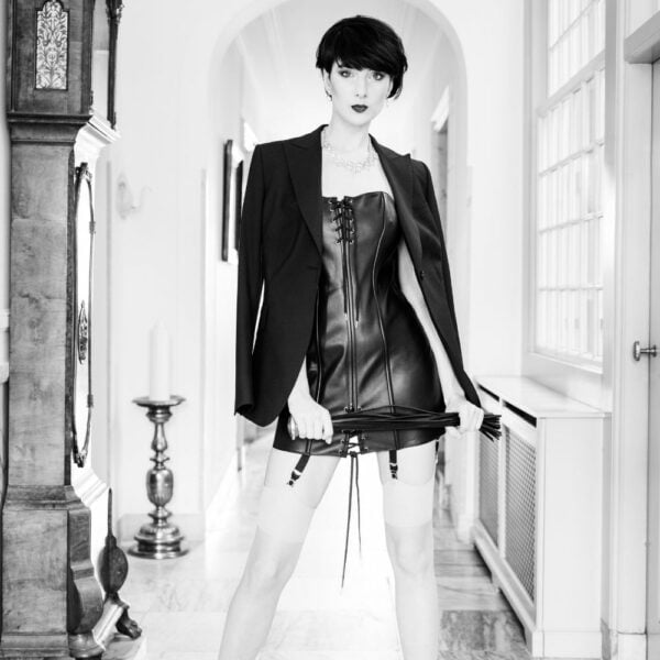 Photo of a Women's Corset Dress with Lace and Whip detail in Cowhide Leather and Soft Black Metal.