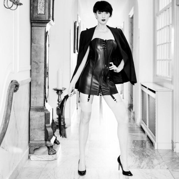Photo of a Women's Corset Dress with Lace and Whip detail in Cowhide Leather and Soft Black Metal.