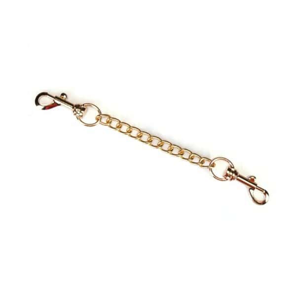 Boudoir Amor handcuffs in pastel pink and black vegan imitation leather. Gold-plated finish, D-ring for fastening. Adjustable buckles and quick-release clips for security and comfort. Ideal for elegant submission play.