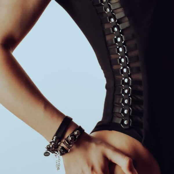 LALITA - Body Accented - HerCuff bracelet Lalita's Accented bodysuit in soft bamboo hugs curves with handmade metal embellishments, and the HerCuff bracelet in Italian leather and sterling silver with hanging hearts creates a sensual, bold contrast.
