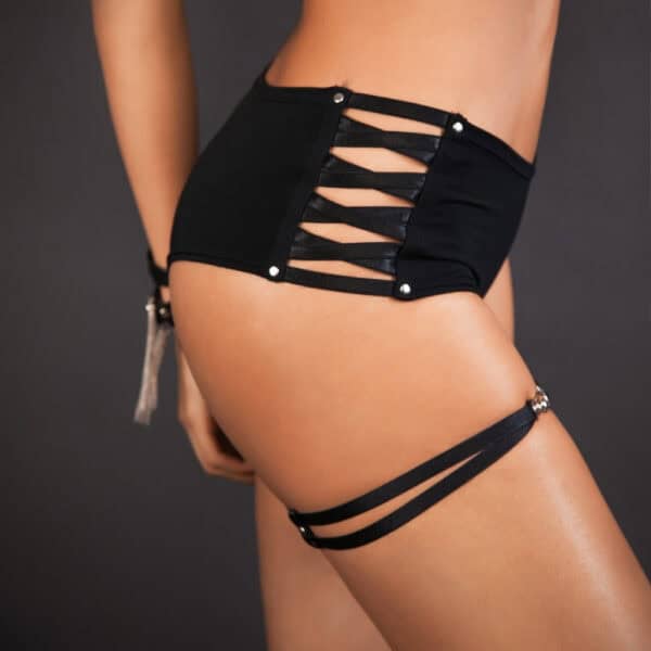 LALITA - Corset Bodyshorts Women's lingerie: a woman wears a black openwork shorty with crossed straps and metal fastenings, combining comfort and sexy elegance.