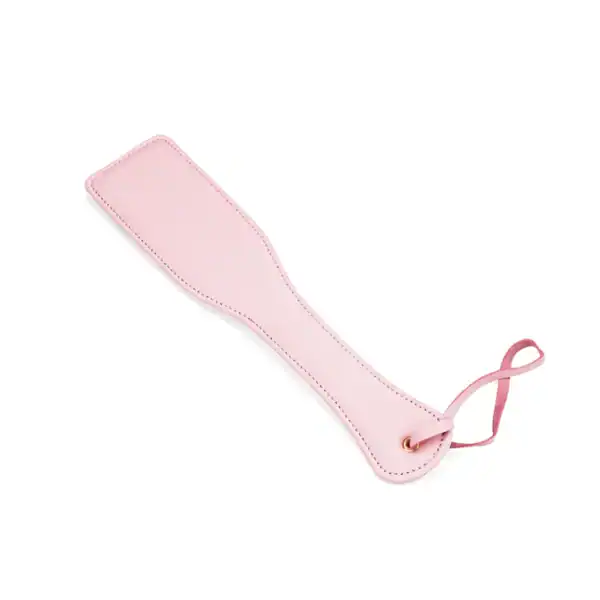Rosafarbenes Lederpaddle aus der Fairy-Kollektion, hergestellt aus weißem und rosafarbenem Lammleder mit roségoldenen Akzenten. Ein raffiniertes BDSM-Accessoire für kontrollierte und elegante Spanking-Spiele.
