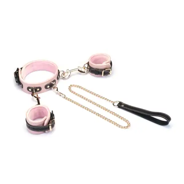 Set collier et menottes LIEBE SEELE en cuir de vache italien rose pâle, noir et doré, reliés par une chaîne dorée. Confort optimal pour les jeux de soumission élégants et raffinés.