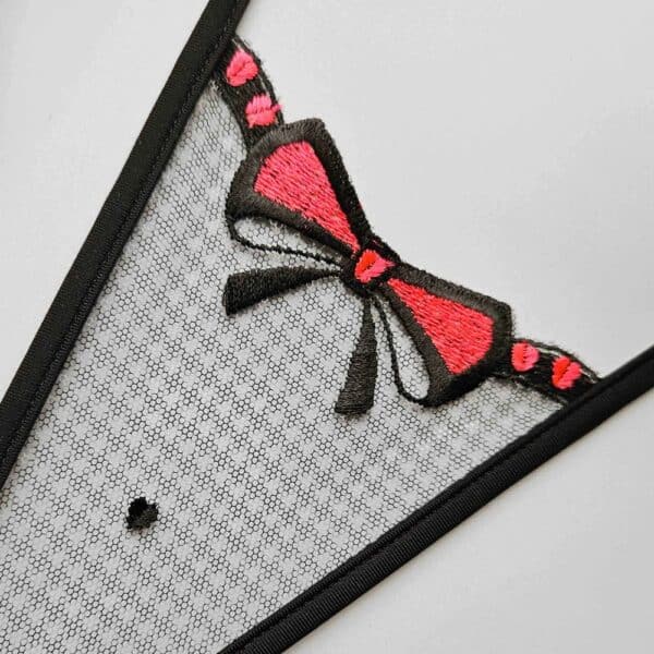 Black and white checkered tulle mini thong with red bow, fine embroidery and graphic cut, Black Dot model by Lucky Cheeks.
