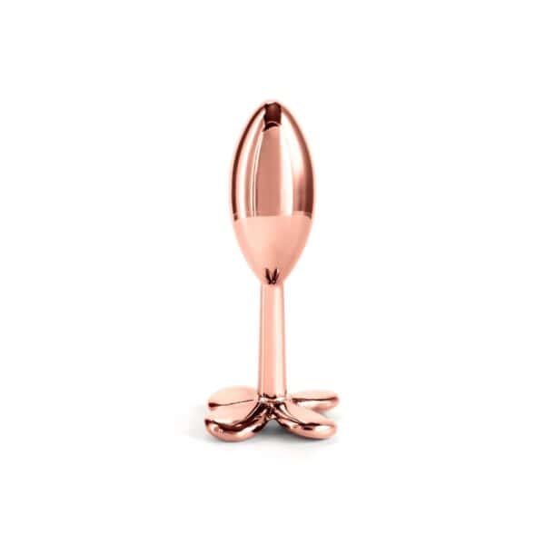 Plug anal en aluminium léger avec base en forme de fleur stylisée, finition chrome or rose, design épuré, étanche et compatible avec tous lubrifiants.