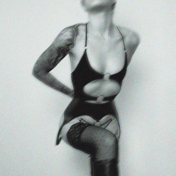 Stretch jersey lingerie combining softness and provocation. Open cut with silver metal rings, picot elastic, back tie and adjustable straps for a personalized fit.