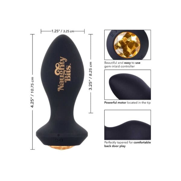 Schwarzer Analplug aus Silikon mit einer Basis, die mit einem facettierten bernsteinfarbenen Schmuckstück verziert ist, in der Hand gehalten, angeboten von Brigade Mondaine Paris.
