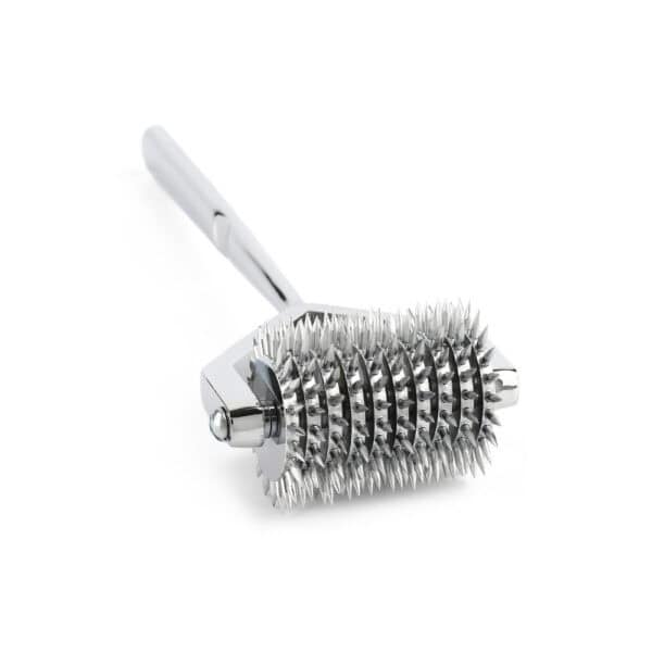 Wartenberg castor in bright stainless steel with serrated wheels, medical design revisited, presented by Brigade Mondaine Paris on light background.