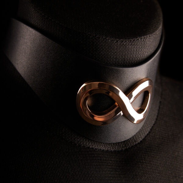 Choker SASKIA IINFYNII in black leather with metallic symbol, graphic choker worn on female bust, body accessory selection Brigade Mondaine Paris