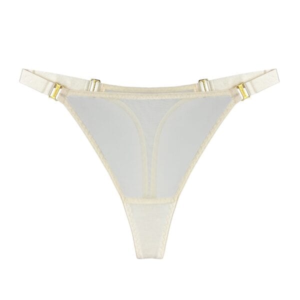 BORDELLE - String Mesh Cream chez Brigade Mondaine Paris Close-up BORDELLE Mesh Cream thong in ivory sheer tulle with thin elastic waistband and gold metallic trim, presented at Brigade Mondaine Paris.