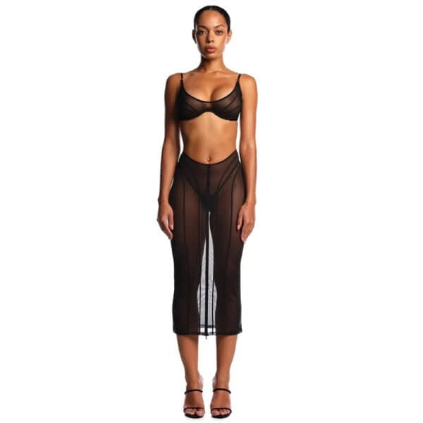 Ensemble ANOESES composé d’une jupe fendue et d’un soutien-gorge en tulle noir, porté par un modèle féminin debout, coupe ajustée, fente centrale et lignes verticales structurées, esthétique fétiche haut de gamme Brigade Mondaine Paris.