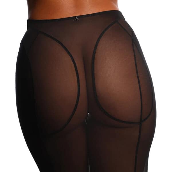 Jupe fendue en tulle noir ANOESES portée par un modèle féminin debout, coupe midi ajustée avec fente centrale et lignes structurées, transparence légère et esthétique fétiche haut de gamme Brigade Mondaine Paris.