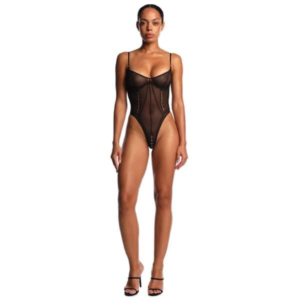 ANOESES black tulle bodysuit worn by an elongated female model, side cut-outs, decorative laces on bust, worn with black stockings and matching collar, high-end fetish aesthetic Brigade Mondaine Paris.