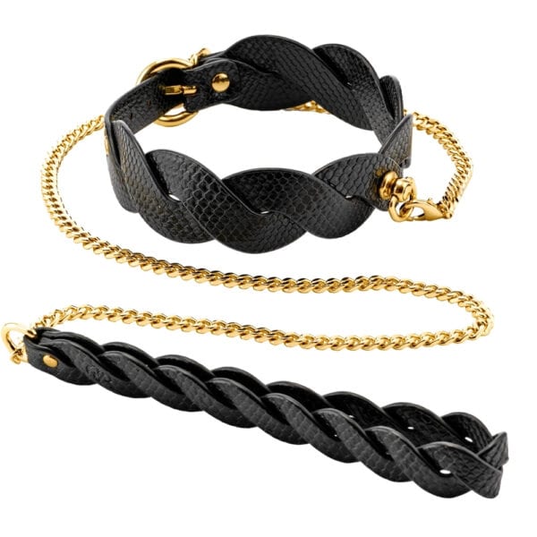 Model wearing a textured black BDSM necklace with gold chain and matching lanyard, restraint accessory offered by Brigade Mondaine Paris.