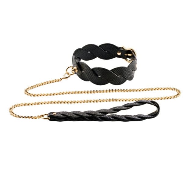 Model wearing a textured black BDSM necklace with gold chain and matching lanyard, restraint accessory offered by Brigade Mondaine Paris.
