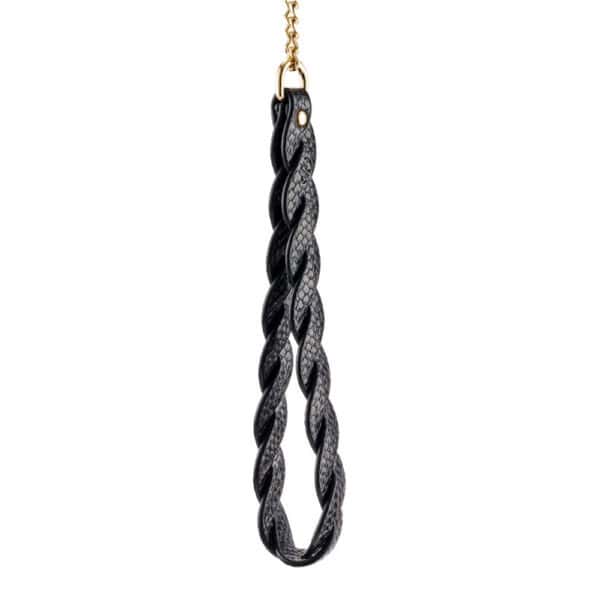 Model wearing a textured black BDSM necklace with gold chain and matching lanyard, restraint accessory offered by Brigade Mondaine Paris.