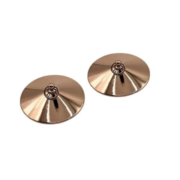 Nippelhalter mit goldenen Ringen Luxus-Design | Brigade Mondaine Ein Paar vergoldeter Übertöpfe aus Metall mit glatter, kreisförmiger Oberfläche, jeweils mit einem kleinen Ring in der Mitte. Sie werden auf weißem Hintergrund in einer minimalistischen, eleganten Ästhetik präsentiert.