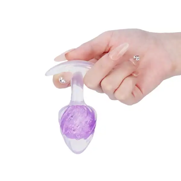 LIEBE SEELE tapón de silicona púrpura con superficie en espiral y base acampanada transparente, de mano sobre fondo blanco, vista detallada del producto