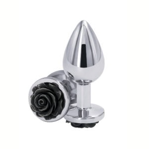 Plug anal en métal poli avec base décorative en forme de rose noire, posé sur fond blanc, sélection Brigade Mondaine Paris.