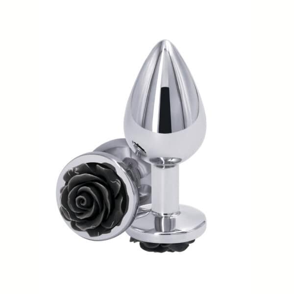 Plug anal en métal poli avec base décorative en forme de rose noire, posé sur fond blanc, sélection Brigade Mondaine Paris.