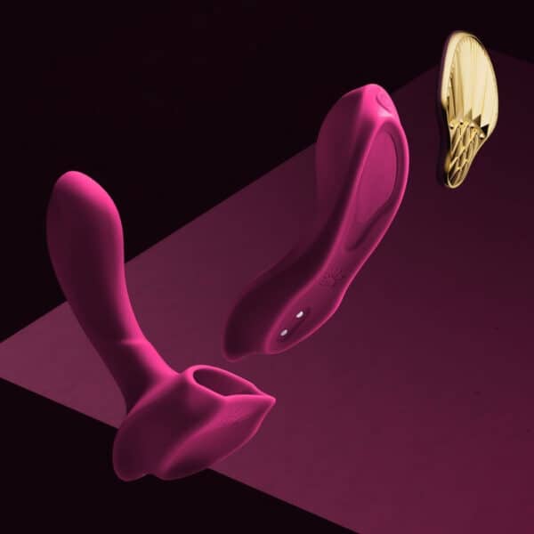 Plum-colored portable vibrator with gold details, ergonomic design and integrated controls, presented on a white background, selection Brigade Mondaine Paris.