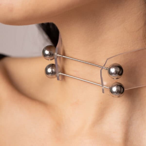 Model wearing Industrial Choker Crystal Perlensau with metallic elements and shiny details, offered by Brigade Mondaine Paris.