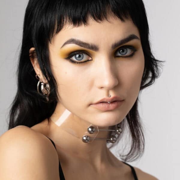 Model wearing Industrial Choker Crystal Perlensau with metallic elements and shiny details, offered by Brigade Mondaine Paris.